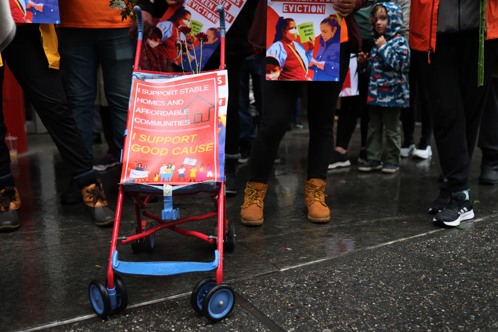 A stroller with a sign supporting the good cause measure at a rally in favor of the measure.