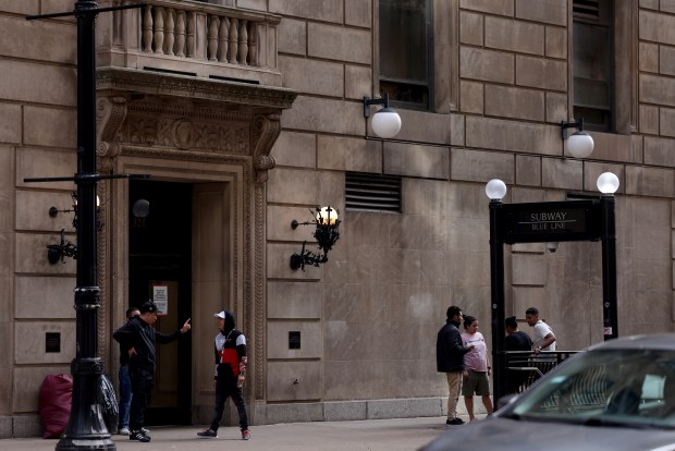 Migrants and others congregate outside the Standard Club building that houses a migrant shelter in downtown Chicago on May 6, 2024. (Antonio Perez/Chicago Tribune)