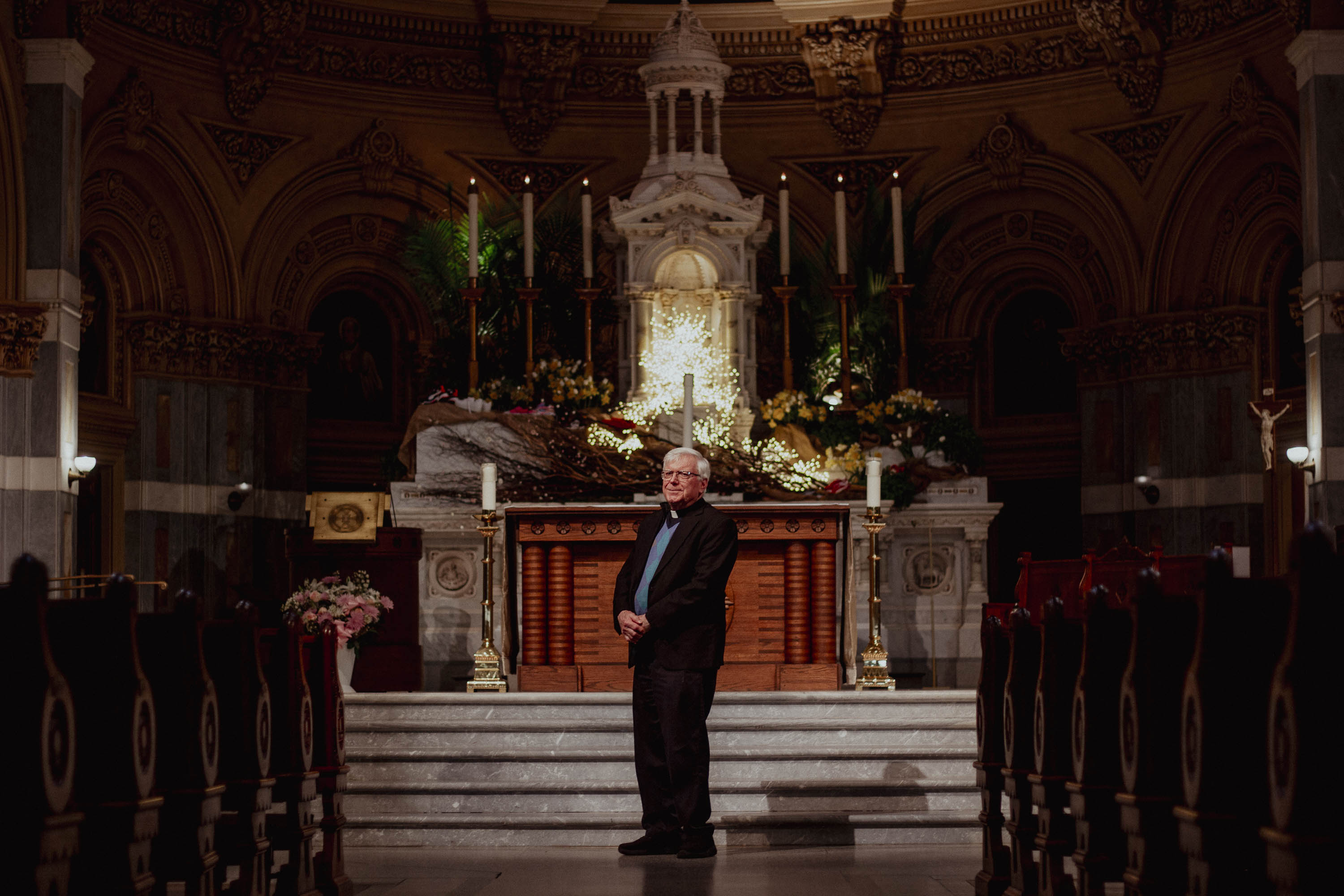 A man poses inside a church