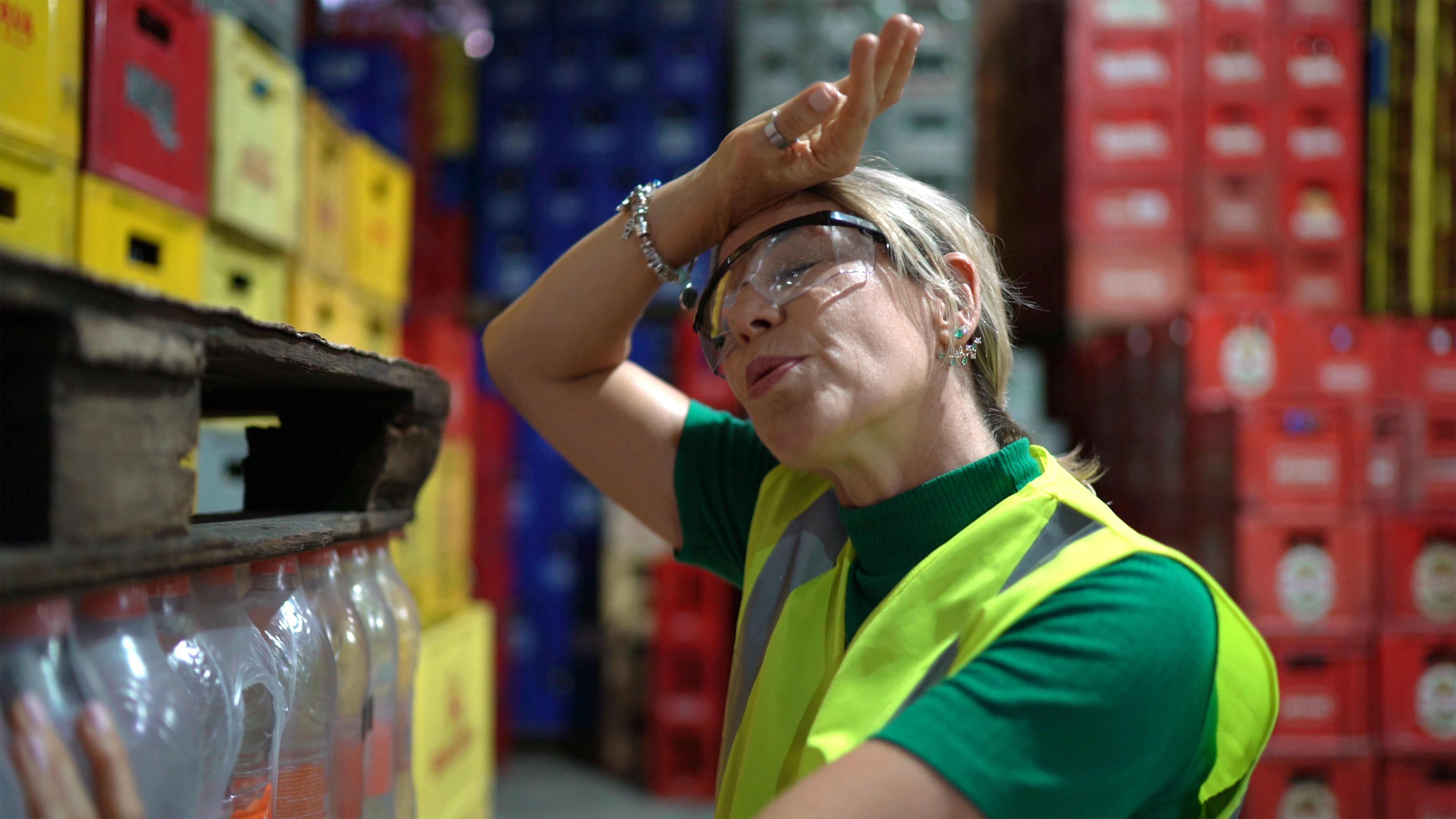 A worker sweats in a warehouse.