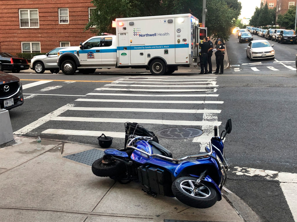 The aftermath of a crash involving a delivery worker on a scooter, on Yellowstone Boulevard, Queens, on Aug. 12, 2022.