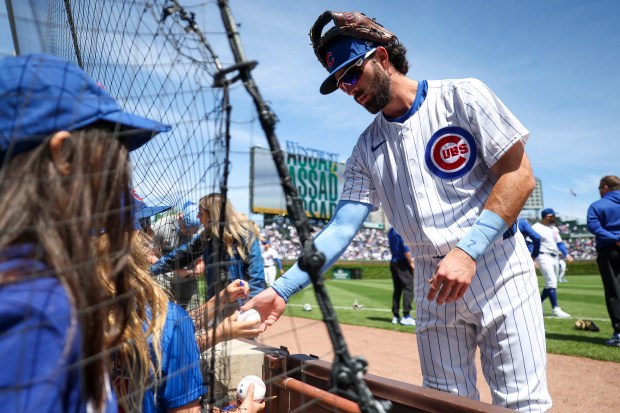 Chicago Cubs shortstop Dansby Swanson (7) signs autographs for fans before the game against the Milwaukee Brewers at Wrigley Field on May 5, 2024. (Eileen T. Meslar/Chicago Tribune)