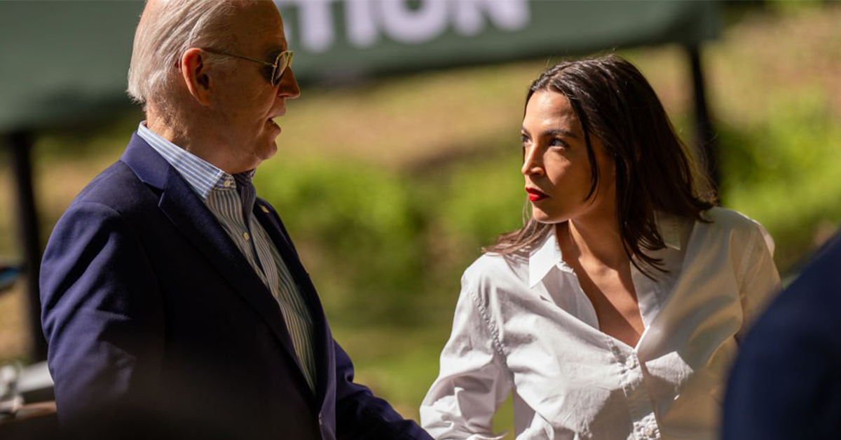 Rep. Alexandria Ocasio-Cortez and President Joe Biden hold hands during a discussion.