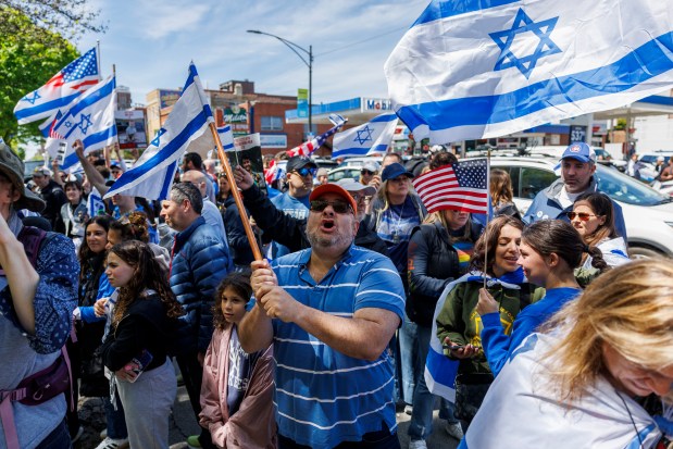 Pro-Israel activists argue with pro-Palestinian activists while members of the Chicago Police department stand between the two groups outside a pro-Palestinian encampment at DePaul University on May 5, 2024, in Chicago. (Armando L. Sanchez/Chicago Tribune)