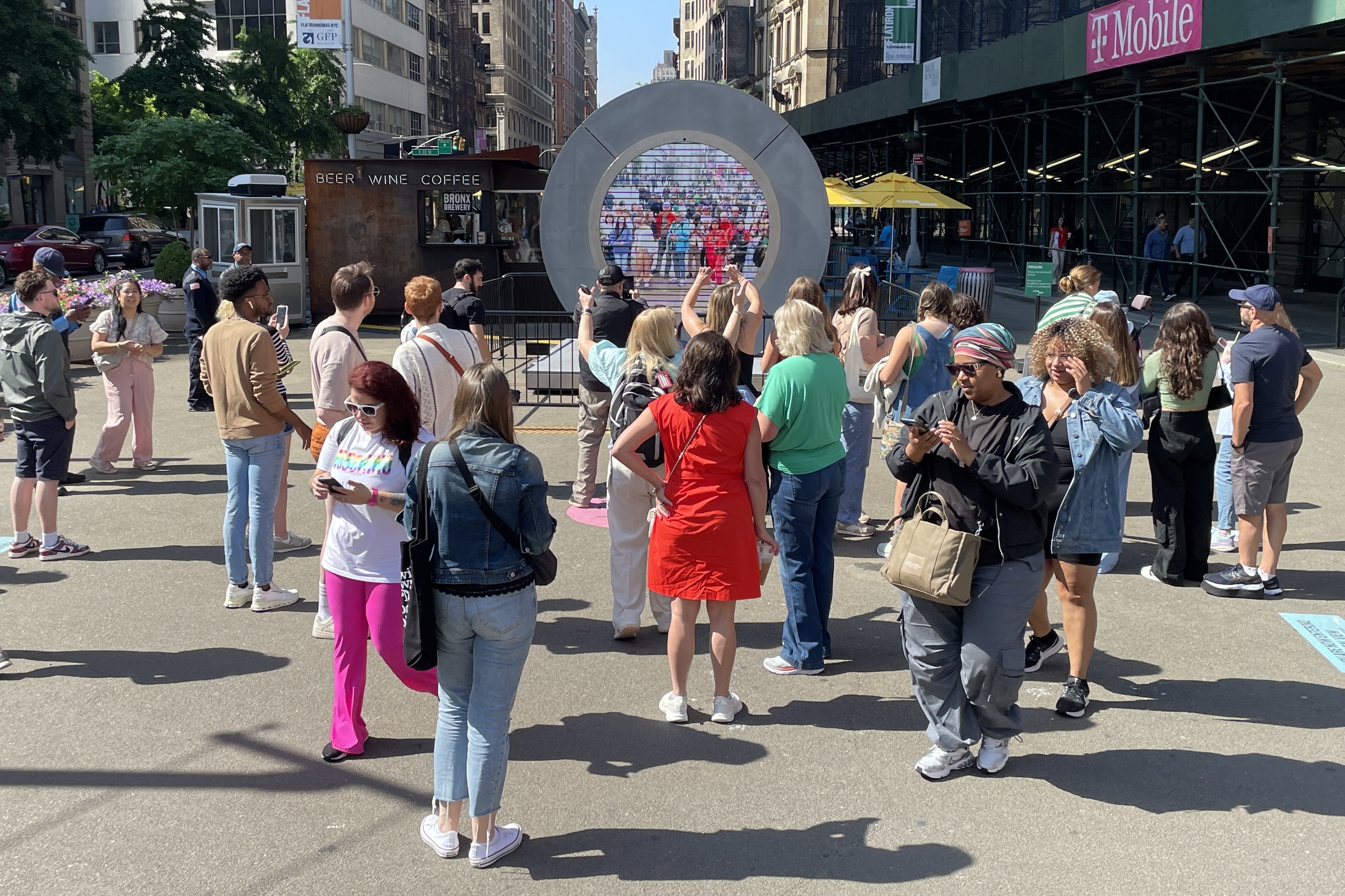 A group of people stands in a pedestrian-only area in the city.