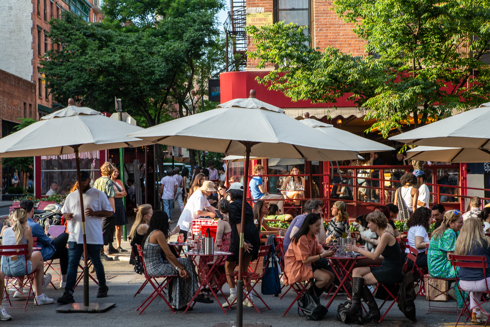 A group of people participate in New York City's outdoor dining.