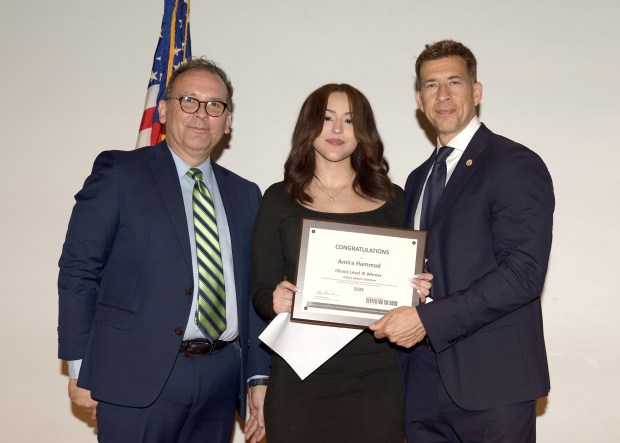 Amira Hammad, a sophomore at Tinley Park High School, is flanked by Illinois State Library Director Greg McCormick and Secretary of State Alexi Giannoulious during a recent ceremony in Springfield where Hammad was presented a first place award in the statewide Letters About Literature contest. (School District 228)