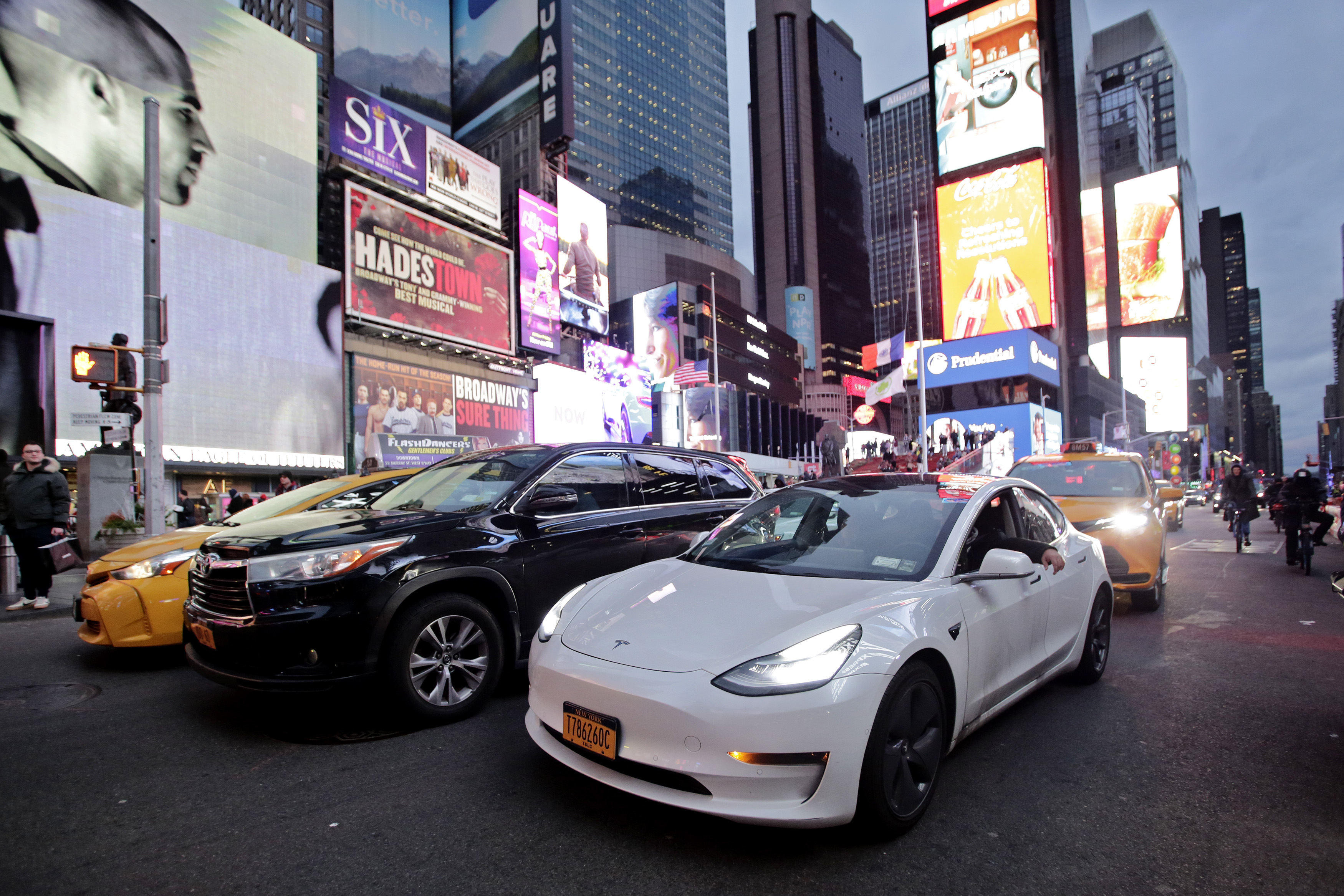 A Tesla car drives at Times Square in New York City.