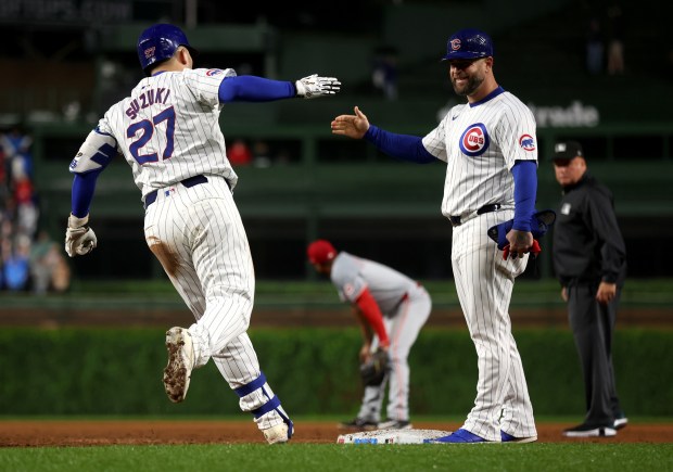 Chicago Cubs right fielder Seiya Suzuki (27) starts to celebrate as he rounds the bases after hitting a grand slam in the second inning of a game against the Cincinnati Reds at Wrigley Field in Chicago on June 1, 2024. (Chris Sweda/Chicago Tribune)