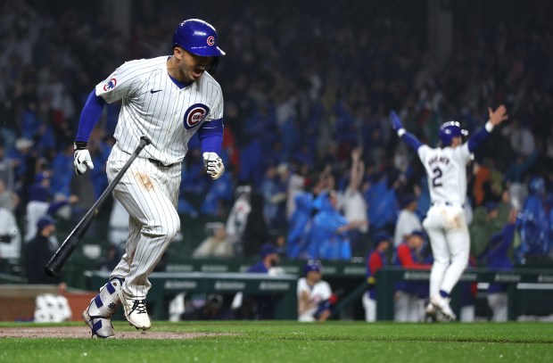 Chicago Cubs right fielder Seiya Suzuki (27) starts to celebrate as he rounds the bases after hitting a grand slam in the second inning of a game against the Cincinnati Reds at Wrigley Field in Chicago on June 1, 2024. (Chris Sweda/Chicago Tribune)