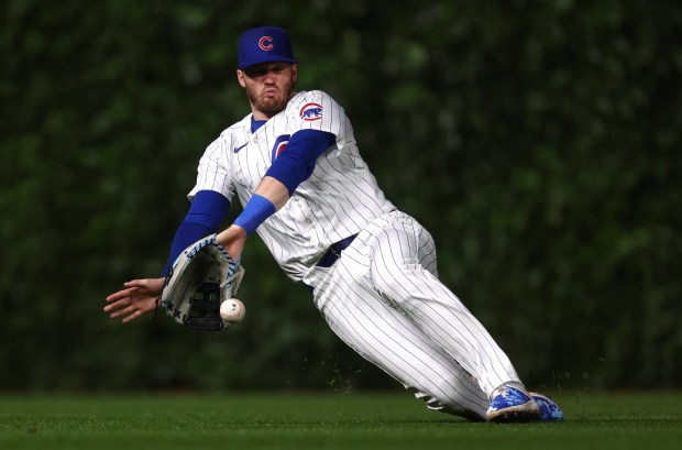 Chicago Cubs left fielder Ian Happ (8) is unable to catch a ball that went for a single for Cincinnati Reds catcher Luke Maile in the fourth inning of a game at Wrigley Field in Chicago on June 1, 2024. (Chris Sweda/Chicago Tribune)