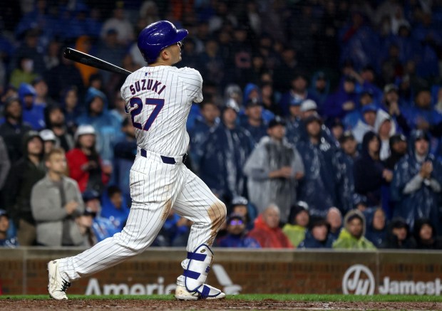 Chicago Cubs right fielder Seiya Suzuki (27) hits a grand slam in the second inning of a game against the Cincinnati Reds at Wrigley Field in Chicago on June 1, 2024. (Chris Sweda/Chicago Tribune)