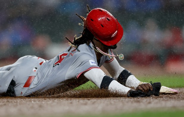 Cincinnati Reds shortstop Elly De La Cruz (44) slide into third base before being tagged out in the fourth inning of a game against the Chicago Cubs at Wrigley Field in Chicago on June 1, 2024. (Chris Sweda/Chicago Tribune)