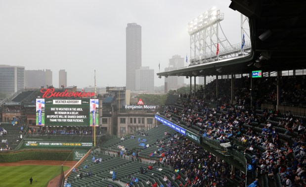 Chicago Cubs fans wait out a rain delay before a scheduled game between the Cubs and the Cincinnati Reds at Wrigley Field in Chicago on June 1, 2024. (Chris Sweda/Chicago Tribune)