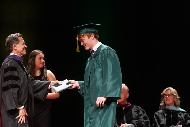 Glenbrook North graduate Joseph Mosko receives his diploma during the school's graduation ceremony at Rosemont Theatre on Sunday, June 2, 2024. (Troy Stolt/for the Pioneer Press)