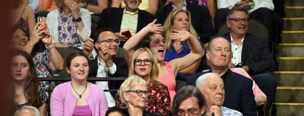 Audience members react to seeing their graduates file into the arena for the 124th annual New Trier Township High School commencement on June 2, 2024 at NOW Arena in Hoffman Estates. (Karie Angell Luc/Pioneer Press)