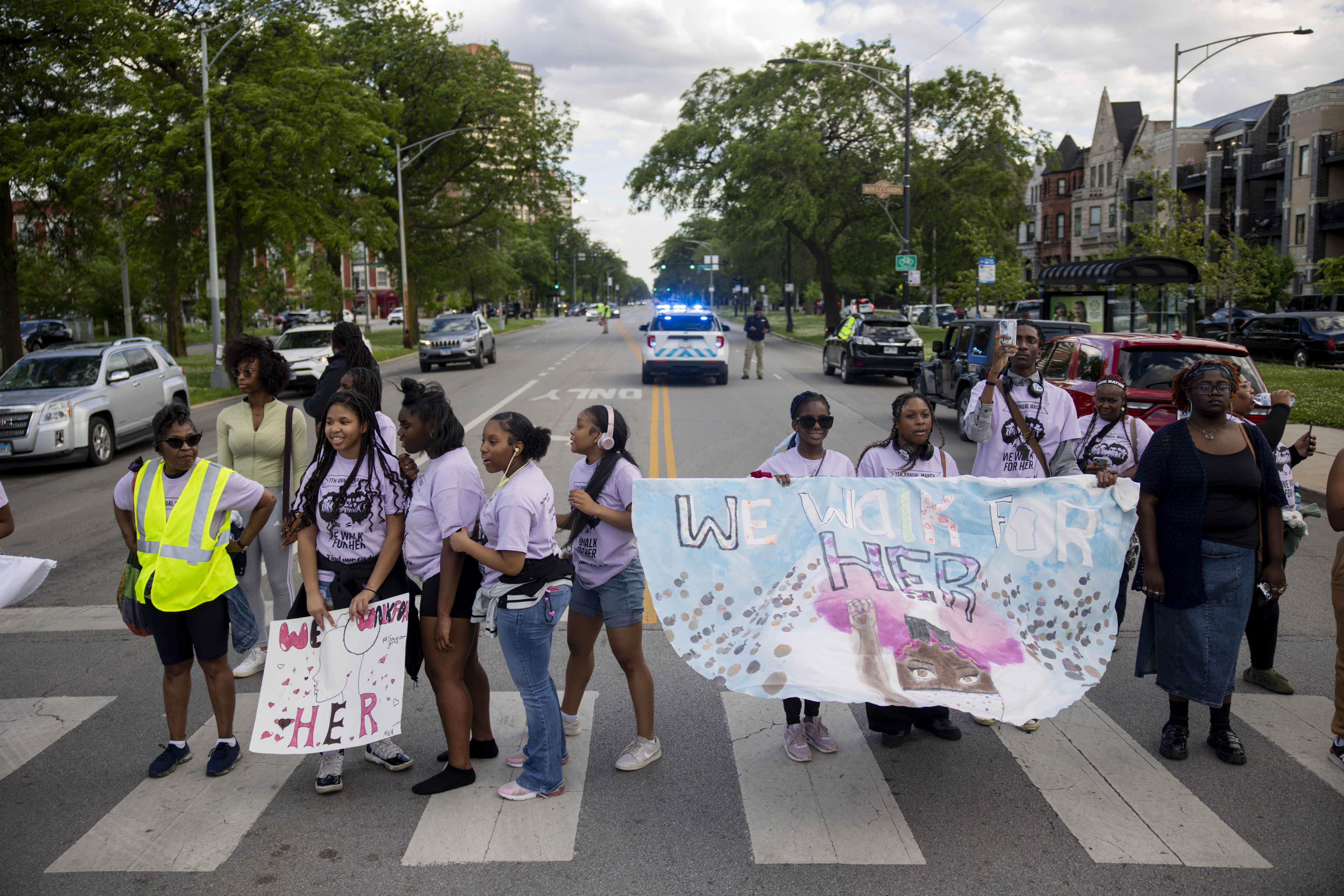 Community members and activists gather at the intersection of South...