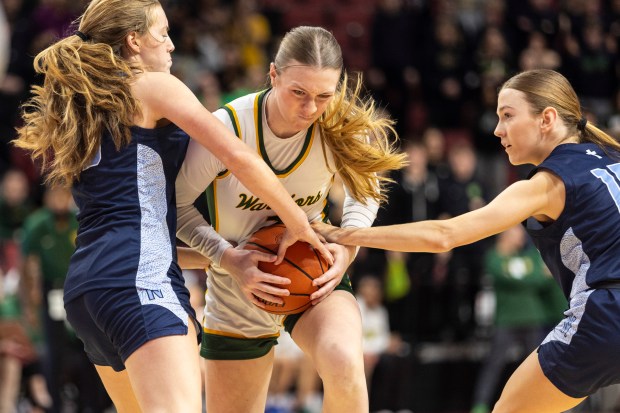 Waubonsie Valley's Hannah Laub drives through Nazareth's Amalia Dray, left, and Mary Bridget Wilson (15) during the Class 4A state semifinal game at CEFCU Arena in Normal on Friday, March 1, 2024. (Vincent D. Johnson / The Beacon-News)