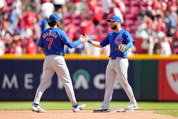 Cubs teammates Dansby Swanson (7) and David Bote celebrate a 4-2 victory over the Reds at Great American Ball Park on June 9, 2024, in Cincinnati. (Jeff Dean/Getty Images)