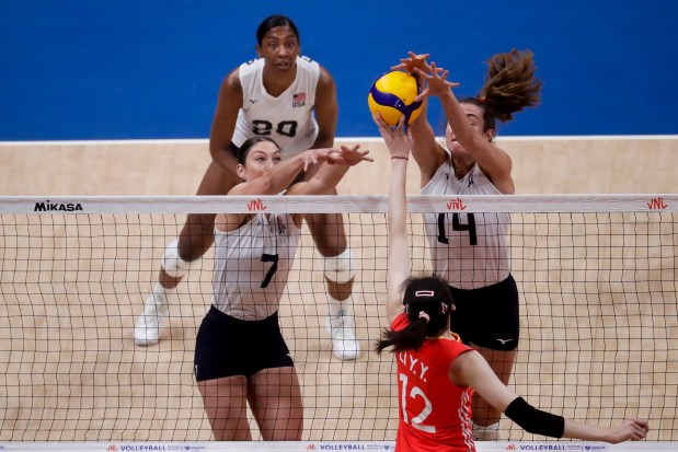 The United States' Anna Hall, right, and Lauren Carlini, left, block a spike by China's Li Yingying during a Volleyball Women's Nations League match at the Maracanazinho stadium in Rio de Janeiro, Brazil, Thursday, May 16, 2024. (AP Photo/Bruna Prado)