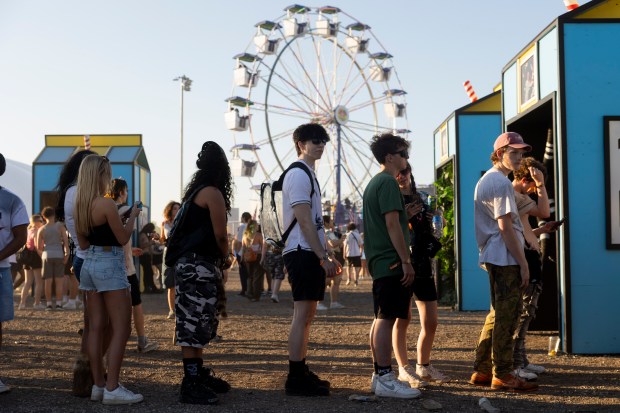 Festival goers wait in line to take photos in a photo booth on June 14, 2024, at the Summer Smash Music Festival at SeatGeek Stadium in Bridgeview. (Vincent Alban/Chicago Tribune)