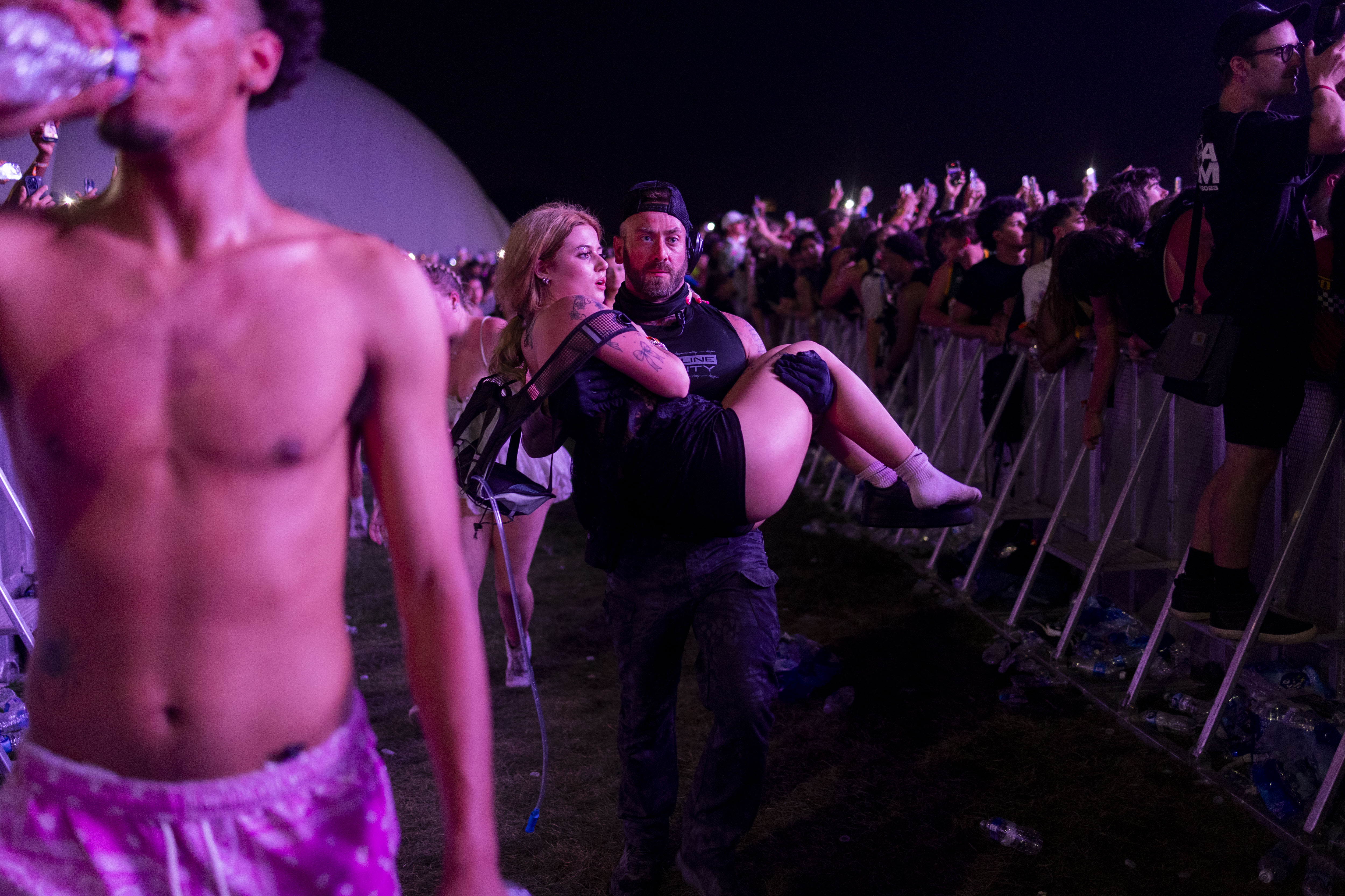 A festival goer is voluntarily removed by security from the...