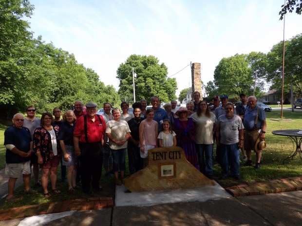 Tamara Briddick, front, fifth from left, of the Gallatin County Historical Society, stands with colleagues and area officials at the dedication last year of a historical marker at the site of a Tent City that housed residents of Shawneetown, Illinois, after a 1937 Ohio River flood wiped out their town. (Tamara Briddick)