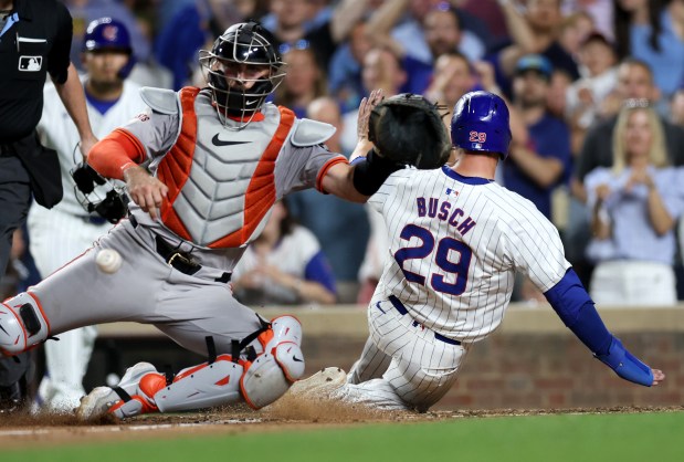 Chicago Cubs first baseman Michael Busch (29) slides in safely at home on a single by Cody Bellinger in the 8th inning of a game against the San Francisco Giants at Wrigley Field in Chicago on June 18, 2024. (Chris Sweda/Chicago Tribune)