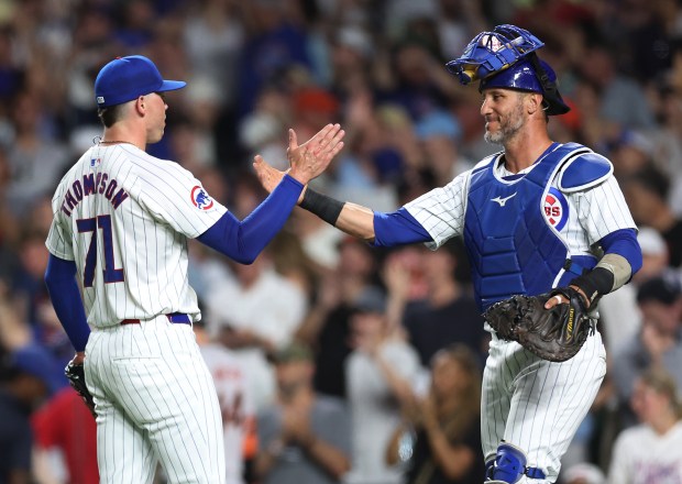 Chicago Cubs relief pitcher Keegan Thompson (71) and catcher Yan Gomes celebrate after closing out the San Francisco Giants in the ninth inning of a game at Wrigley Field in Chicago on June 18, 2024. (Chris Sweda/Chicago Tribune)