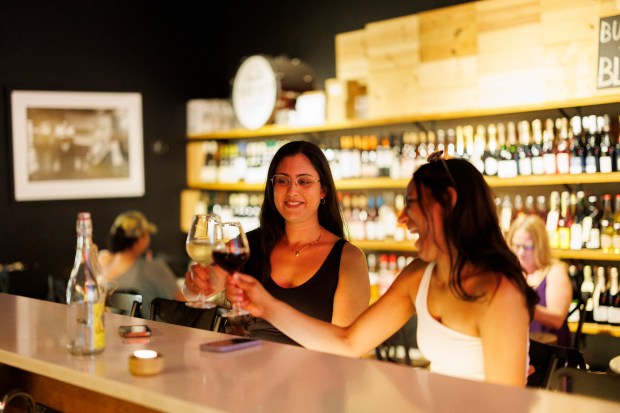 Jaina Shah, left, and Anusha Manjunath drink wine at the bar at Printers Row Wine Bar and Shop on June 16, 2024, in Chicago. (Armando L. Sanchez/Chicago Tribune)