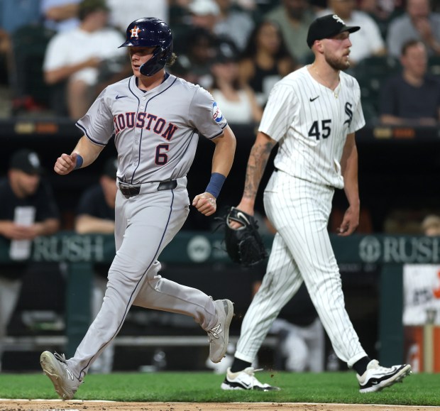 Houston Astros center fielder Jake Meyers (6) passes by Chicago White Sox starting pitcher Garrett Crochet (45) as Meyers crosses home plate to score on a single by teammate César Salazar in the sixth inning of a game at Guaranteed Rate Field in Chicago on June 19, 2024. (Chris Sweda/Chicago Tribune)