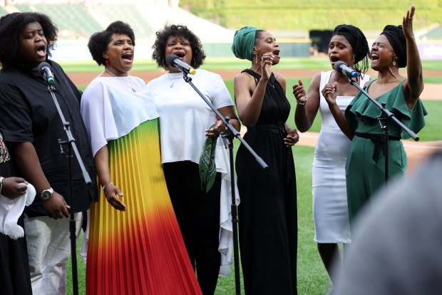 Members of the Bourné family sing during a Juneteenth Day celebration before a White Sox-Astros game on June 19, 2024, at Guaranteed Rate Field. (Chris Sweda/Chicago Tribune)