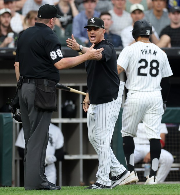 Chicago White Sox manager Pedro Grifol (5) argues with the home plate umpire after a call was reversed following a video replay in the first inning of a game against the Houston Astros at Guaranteed Rate Field in Chicago on June 19, 2024. Chicago White Sox outfielder Tommy Pham (28) was initially called for a hit by pitch, but the umpires changed the call to a foul ball after the review. (Chris Sweda/Chicago Tribune)