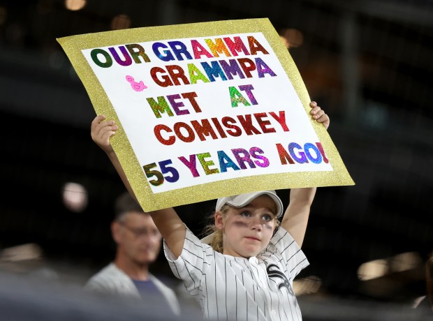 A young fan shows some love for her family and the White Sox in the ninth inning of a game against the Astros on June 19, 2024, at Guaranteed Rate Field. (Chris Sweda/Chicago Tribune)