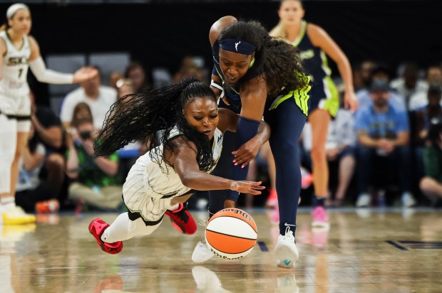 Chicago Sky guard Dana Evans (11) tries to protect the ball from Dallas Wings Arike guard Ogunbowale (24) during the game at Wintrust Arena on June 20, 2024. (Eileen T. Meslar/Chicago Tribune)