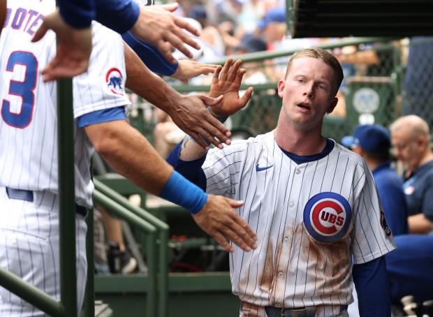 Cubs centerfielder Pete Crow-Armstrong is congratulated after scoring on an RBI double by catcher Tomás Nido in the sixth inning against the Mets at Wrigley Field on June 22, 2024, in Chicago. (John J. Kim/Chicago Tribune)