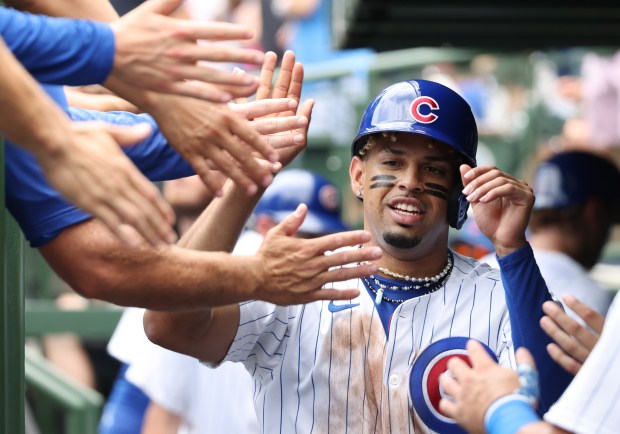 Cubs third baseman Christopher Morel is congratulated after scoring off an RBI double by shortstop Dansby Swanson in the first inning against the Mets at Wrigley Field on June 22, 2024, in Chicago. (John J. Kim/Chicago Tribune)