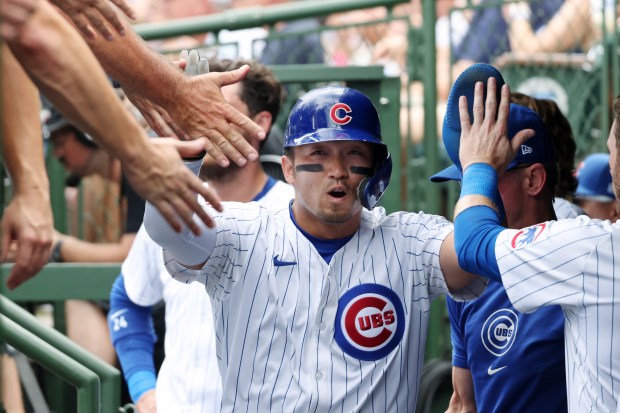 Cubs designated hitter Seiya Suzuki is congratulated after scoring off a single by third baseman Christopher Morel in the first inning against the Mets at Wrigley Field on June 22, 2024, in Chicago. (John J. Kim/Chicago Tribune)