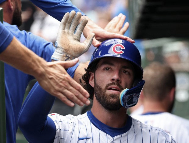 Cubs shortstop Dansby Swanson is congratulated after scoring off an RBI triple by centerfielder Pete Crow-Armstrong in the first inning against the Mets at Wrigley Field on June 22, 2024, in Chicago. (John J. Kim/Chicago Tribune)