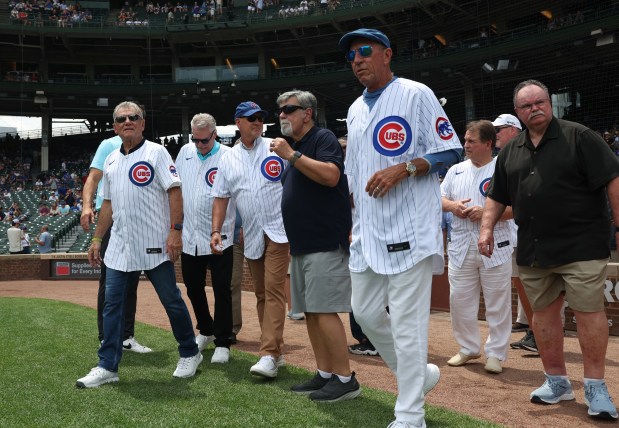 Former Cubs players head to mound to be recognized as part of the 1984 Cubs before a game against the Mets at Wrigley Field on June 22, 2024, in Chicago. (John J. Kim/Chicago Tribune)