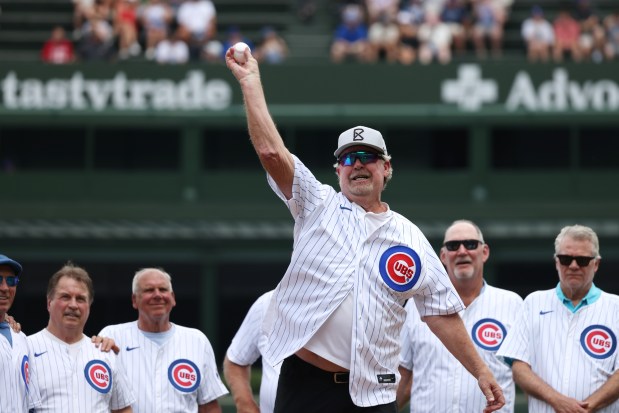 Former Cubs player Rick Sutcliffe throws out a ceremonial first pitch, with fellow players from the 1984 Cubs in the background, before a game against the Mets at Wrigley Field on June 22, 2024, in Chicago. (John J. Kim/Chicago Tribune)