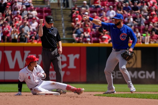 Cubs second baseman David Bote points to left fielder Ian Happ after forcing out the Reds' Santiago Espinal during the seventh inning Sunday, June 9, 2024, in Cincinnati. (AP Photo/Joshua A. Bickel)