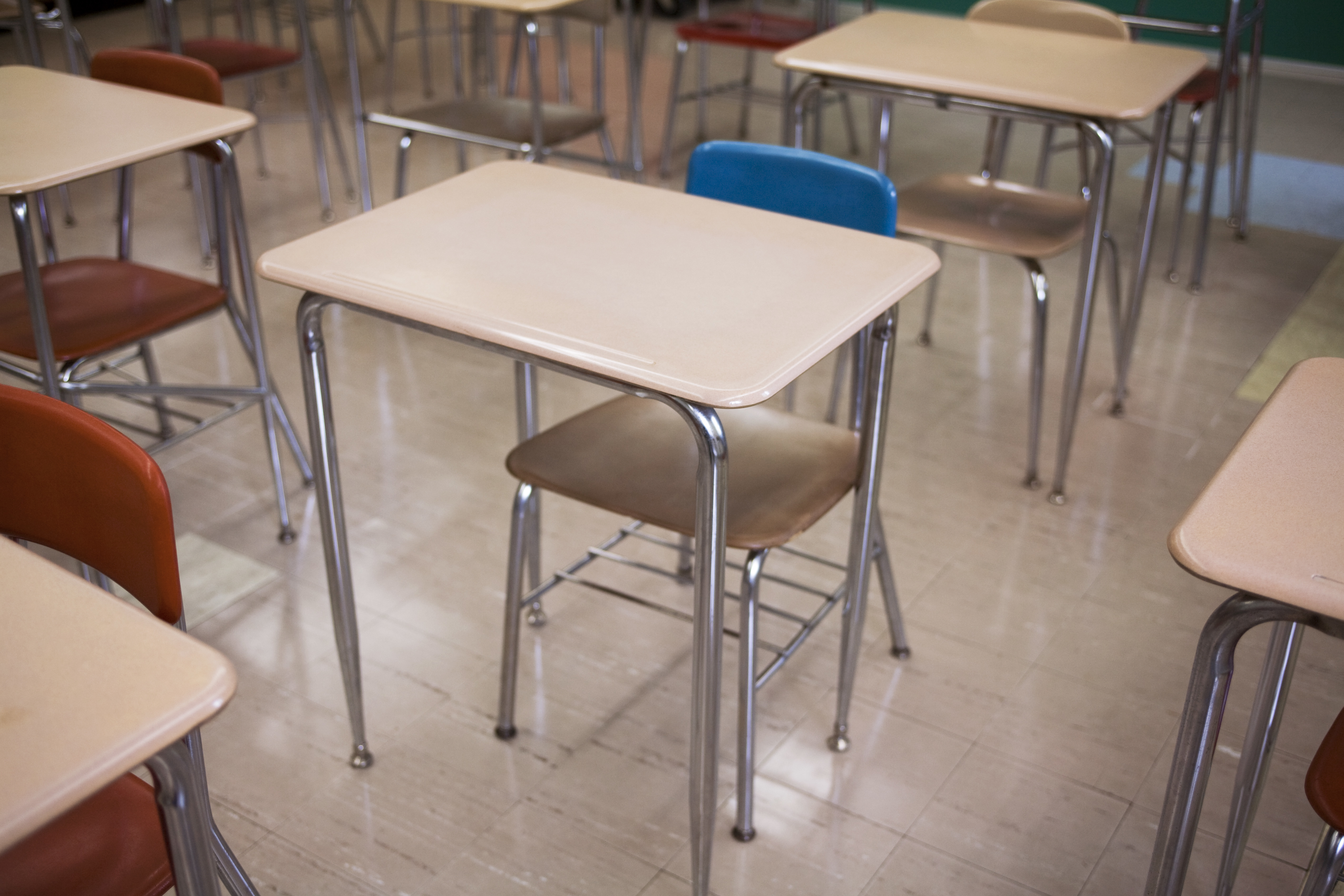 Empty desks and chairs in a classroom.