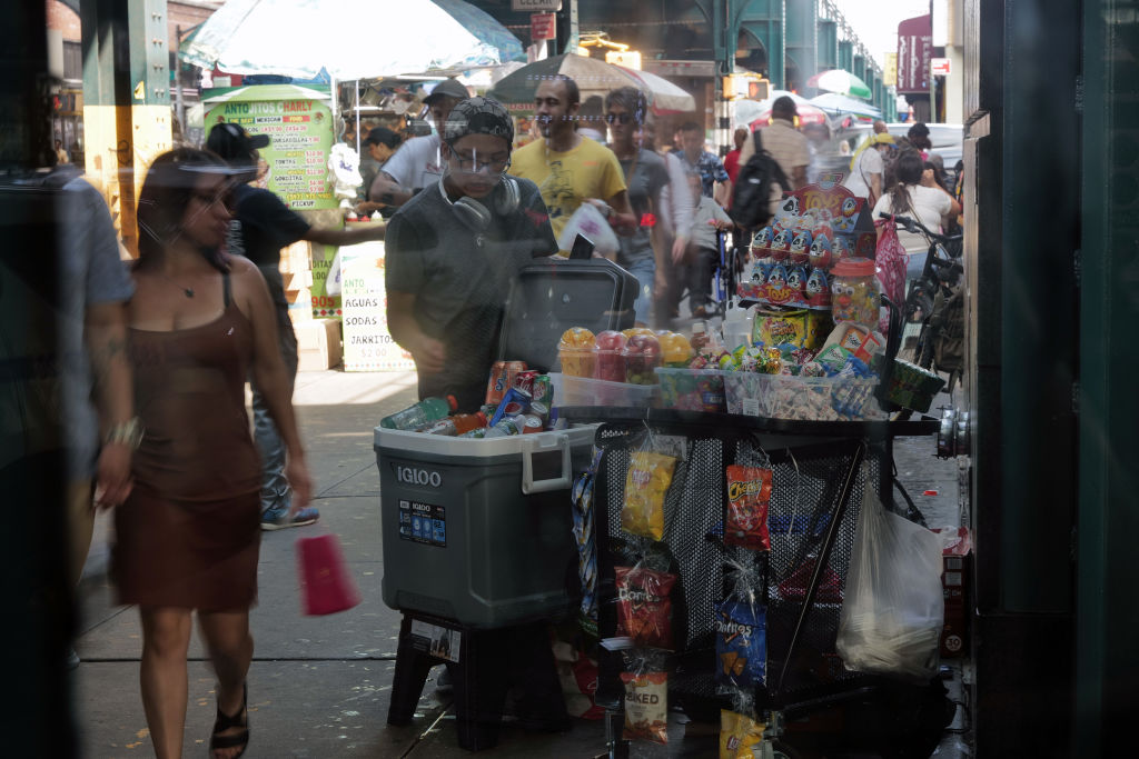 A street vendor sells products along Roosevelt Avenue in Queens, on Aug. 16, 2023. The number of street vendors in the city has surged amid an immigration wave that started in 2022. Many of those vending do so without city licenses.