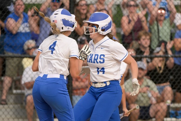 St. Charles North's Addy Umlauf (4) congratulates Abby Zawadzki (14) after she drove in 3 runs to take the lead against Whitney Young during the Class 4A St. Charles North Supersectional in St. Charles on Monday, June 3, 2024. (Mark Black / for the Beacon-News)
