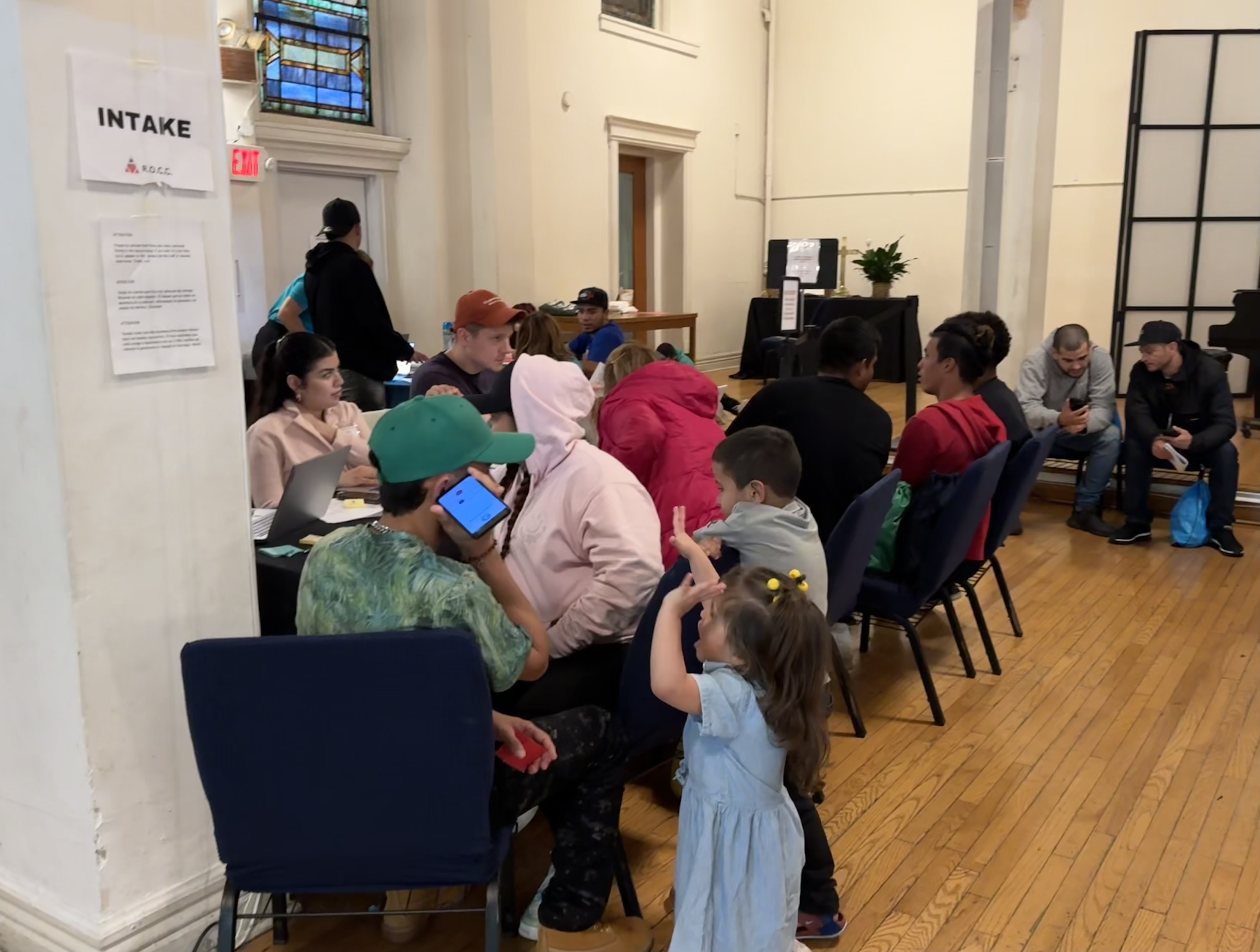 Migrants awaiting assistance at Metro Baptist Church in Midtown.
