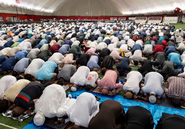 Men pray as the Islamic Community Center of Illinois holds its annual Eid-ul-Adha service on June 16, 2024, at The Dome Parkway Bank Sports Complex in Des Plaines. (Brian Cassella/Chicago Tribune)