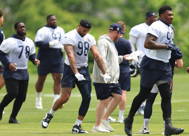 Chicago Bears defensive tackle Michael Dwumfour (78), defensive end Montez Sweat (98), and Chicago Bears defensive tackle Gervon Dexter Sr. (99) run towards another station during minicamp at Halas Hall on June 4, 2024, in Lake Forest. (Stacey Wescott/Chicago Tribune)