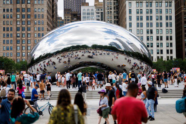 Visitors walk around Cloud Gate, also known as The Bean, at Millennium Park on June 23, 2024, in Chicago. The sculpture officially reopened Sunday morning. (Armando L. Sanchez/Chicago Tribune)