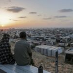 Palestinians displaced by the Israeli air and ground offensive on the Gaza Strip sit at a makeshift tent camp in Khan Younis, Gaza, Tuesday, June 18, 2024. (AP Photo/Jehad Alshrafi)